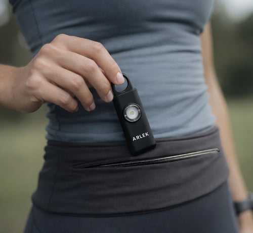 ARLEK safety alarm worn in a running belt for quick access while running